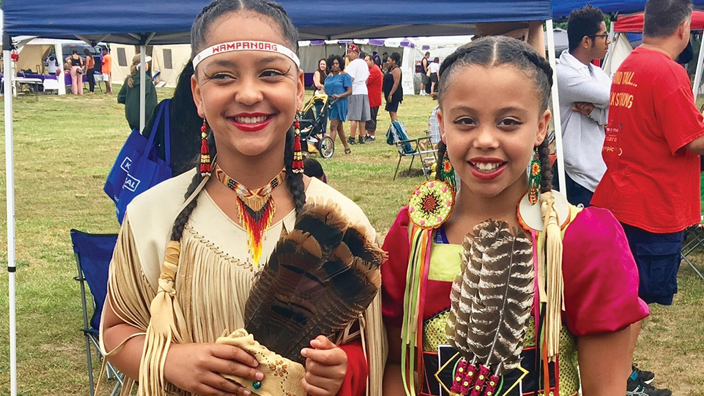 young members of the Mashpee Wampanoag Tribe in traditional outfits
