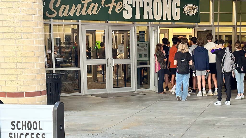 Students wait to go through metal detectors to enter Santa Fe High School 