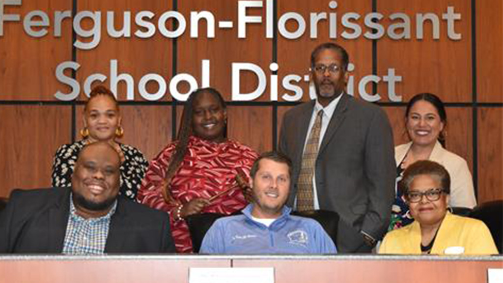 A group picture shows the seven members of Missouri's Ferguson-Florissant School Board.
