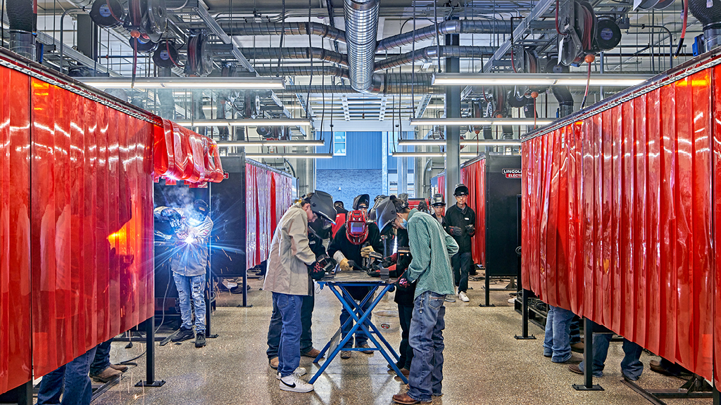 High school students practice welding. 