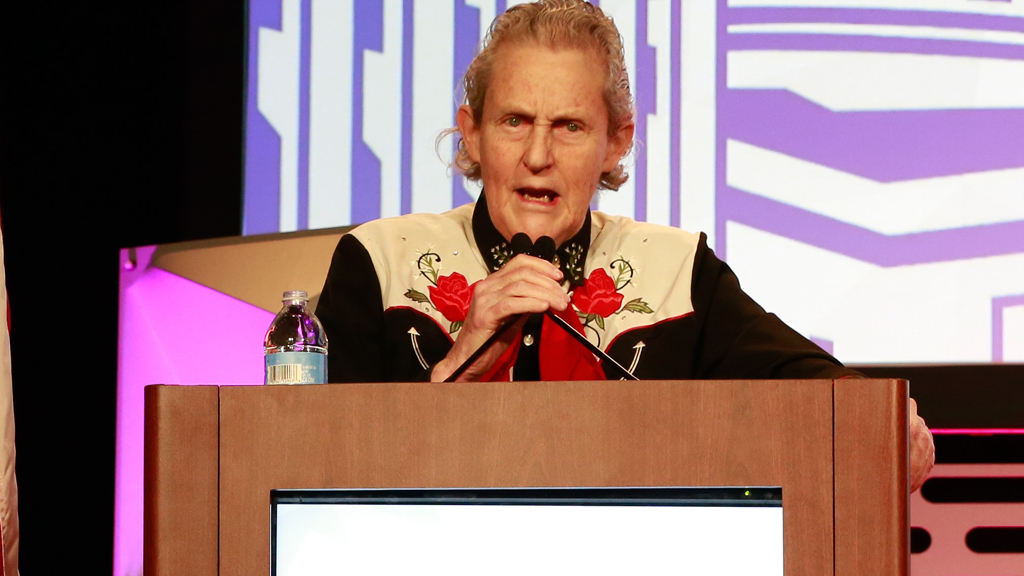 Inventor and autism education activist Temple Grandin speaks from a podium. 