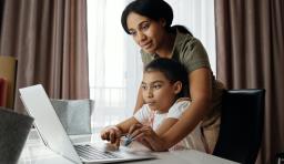 Adult and child looking at a laptop